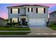 Two-story home with red shutters, manicured lawn, flowerbeds and driveway at 3829 Allegany Ln, Sanford, FL 32771