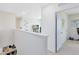 Bright hallway with modern white walls, leading to a room with neutral carpeting at 3829 Allegany Ln, Sanford, FL 32771