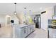 Open kitchen with a large island, gray cabinets and stainless steel appliances at 3829 Allegany Ln, Sanford, FL 32771