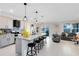 Open kitchen with granite counters, gray cabinets and an island with seating at 3829 Allegany Ln, Sanford, FL 32771