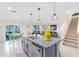 Open kitchen with a large island and stairs leading to second level at 3829 Allegany Ln, Sanford, FL 32771