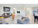 Inviting living room with tile floors, grey sofas, and stairway access at 3829 Allegany Ln, Sanford, FL 32771