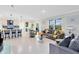 Open-concept living room with breakfast bar, leading to a well-lit dining area and kitchen at 3829 Allegany Ln, Sanford, FL 32771