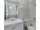 This bathroom features white cabinets, a white toilet, and a shower/tub with white tile surround at 4136 Pershing Pointe Pl # 2, Orlando, FL 32822