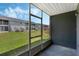 Relaxing screened patio overlooking the green lawn in the community at 4136 Pershing Pointe Pl # 2, Orlando, FL 32822