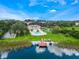 Aerial view of the lake community featuring a pool, tennis courts, and dock with kayaks at 4332 Lake Underhill Rd # 12D10, Orlando, FL 32803