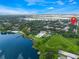 Community aerial view showcases the lake, pool, tennis courts, and surrounding landscape at 4332 Lake Underhill Rd # 12D10, Orlando, FL 32803