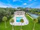 Lake community aerial view shows pool, tennis courts and lush green landscaping with surrounding townhomes at 4332 Lake Underhill Rd # 12D10, Orlando, FL 32803