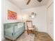 Comfortable bedroom featuring wood floors, a rocking chair, and eclectic wall art at 4332 Lake Underhill Rd # 12D10, Orlando, FL 32803