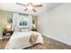 Bright bedroom with wood flooring, a ceiling fan, neutral paint, and coordinated decor at 4332 Lake Underhill Rd # 12D10, Orlando, FL 32803