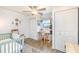 Cozy bedroom featuring wood floors, a rocking chair, a desk, and plenty of natural light at 4332 Lake Underhill Rd # 12D10, Orlando, FL 32803