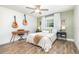 Cozy bedroom featuring wood floors, a ceiling fan, and eclectic decorations at 4332 Lake Underhill Rd # 12D10, Orlando, FL 32803