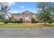 Exterior shot of brick apartment building with well-maintained landscaping and classic architectural details at 4332 Lake Underhill Rd # 12D10, Orlando, FL 32803