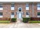 Charming brick building featuring a white door with an arched transom window and manicured landscaping at 4332 Lake Underhill Rd # 12D10, Orlando, FL 32803