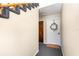 Hallway featuring a white door adorned with a wreath, leading to the interior of the residence at 4332 Lake Underhill Rd # 12D10, Orlando, FL 32803