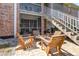 Inviting patio featuring four wooden chairs, a table, and convenient staircase access at 4332 Lake Underhill Rd # 12D10, Orlando, FL 32803