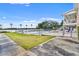 Community pool and lake view from outside the gated fence on a sunny day with lounge chairs at 4332 Lake Underhill Rd # 12D10, Orlando, FL 32803
