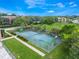 Aerial view of community tennis courts, surrounded by lush greenery and convenient sidewalk access at 4332 Lake Underhill Rd # 12D10, Orlando, FL 32803