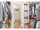 Spacious walk-in closet featuring built-in shelving and easy access to the ensuite bathroom at 4332 Lake Underhill Rd # 12D10, Orlando, FL 32803
