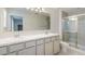 Bathroom featuring double sinks, shower, toilet, and neutral color palette at 4725 Coral Castle Dr, Kissimmee, FL 34746
