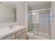 Bathroom featuring shower with glass door, tiled walls, and a single sink vanity at 4725 Coral Castle Dr, Kissimmee, FL 34746