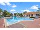 Sparkling community pool with lounge chairs and lush landscaping at 4725 Coral Castle Dr, Kissimmee, FL 34746