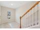 Bright entryway featuring tiled floors, a staircase, and a window providing natural light at 4725 Coral Castle Dr, Kissimmee, FL 34746