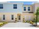 Charming two-story townhome with colorful siding and well-manicured landscaping at 4725 Coral Castle Dr, Kissimmee, FL 34746