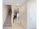 Inviting foyer with staircase and view into the living area at 4725 Coral Castle Dr, Kissimmee, FL 34746