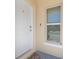 Close-up of the front door with a smart lock, doorbell, and welcome mat at 4725 Coral Castle Dr, Kissimmee, FL 34746