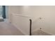Upstairs hallway featuring carpeted floors and decorative railing at 4725 Coral Castle Dr, Kissimmee, FL 34746