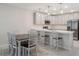 Bright, open kitchen with stainless steel appliances and breakfast bar seating at 4725 Coral Castle Dr, Kissimmee, FL 34746