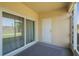 Outdoor patio features sliding glass doors to yard and a doorway to access storage at 4725 Coral Castle Dr, Kissimmee, FL 34746