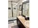 Bright bathroom featuring dual sinks, granite countertops, and a spacious walk-in shower at 5114 Hawkstone Dr, Sanford, FL 32771