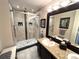 Nicely tiled bathroom with a glass shower enclosure, a vanity with solid surface counter, and a large mirror at 5114 Hawkstone Dr, Sanford, FL 32771
