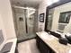Modern bathroom featuring a glass-enclosed shower with custom tile work and a granite-topped vanity at 5114 Hawkstone Dr, Sanford, FL 32771