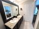 Well-lit bathroom with double sinks, a large mirror, and modern fixtures, offering a clean and functional space at 5114 Hawkstone Dr, Sanford, FL 32771