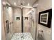 Contemporary bathroom features a glass-enclosed shower with unique mosaic floor and tiled walls at 5114 Hawkstone Dr, Sanford, FL 32771