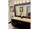 Bathroom features vanity with granite countertop, double sinks, and large mirror at 5114 Hawkstone Dr, Sanford, FL 32771