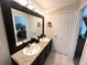 Bathroom showcasing double sinks, a large mirror, and access to a bedroom and a separate toilet room at 5114 Hawkstone Dr, Sanford, FL 32771