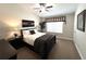 Bedroom features neutral walls, a ceiling fan, a window with blinds, and tasteful decor and furniture at 5114 Hawkstone Dr, Sanford, FL 32771