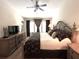 Spacious main bedroom suite with a ceiling fan, large dresser, and natural light from several large windows at 5114 Hawkstone Dr, Sanford, FL 32771