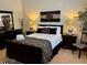 Bedroom with decorative lamps, hardwood bed frame and zebra rug at 5114 Hawkstone Dr, Sanford, FL 32771