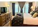 Bedroom with large window and drapes, decorative lamps and warm ambiance at 5114 Hawkstone Dr, Sanford, FL 32771