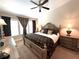 Elegant bedroom featuring a ceiling fan, neutral walls, and lots of natural light from large windows at 5114 Hawkstone Dr, Sanford, FL 32771