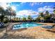 Beautiful community pool with comfortable lounge chairs and swaying palm trees at 5114 Hawkstone Dr, Sanford, FL 32771
