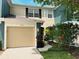 Charming home featuring a one-car garage and beautifully landscaped front yard with vibrant flowers at 5114 Hawkstone Dr, Sanford, FL 32771