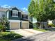 Inviting townhomes featuring two-car garages and lush landscaping, enhancing the curb appeal at 5114 Hawkstone Dr, Sanford, FL 32771