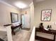 Inviting foyer featuring a decorative mirror, dark wood accent tables, and a welcoming front door at 5114 Hawkstone Dr, Sanford, FL 32771