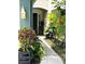 Well-lit walkway to the front door with beautiful, lush landscaping on either side at 5114 Hawkstone Dr, Sanford, FL 32771
